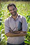 Farmer standing in cornfield