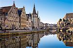 Belgium, Flanders, Ghent (Gent). The Leie River and buildings along Graslei quay at dawn.