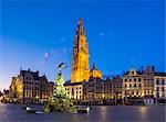 Belgium, Flanders, Antwerp (Antwerpen). Onze-Lieve-Vrouwekathedraal (Cathedral of Our Lady) and statue of Silvius Brabo on Grote Markt square at dawn.