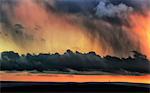 England, West Yorkshire, Calderdale. Dramatic skies at sunset from the hills above Halifax looking towards Stoodley Pike.