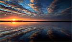 England, Calderdale. Dramatic clouds at sunset reflected in Ringstone Edge Reservoir.