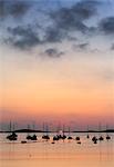 England, Isles of Scilly, St Marys. Boats moored off St Marys island at sunset.