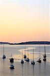England, Isles of Scilly, St Marys. Boats moored off St Marys island at dusk.