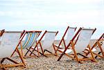 England, Suffolk, Aldeburgh. Empty deckchairs on the shingle beach.
