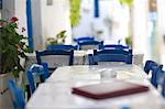 Greece, Amorgos, Chora. Dining tables and chairs at a restaurant.
