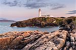 Fanad Head (Fánaid) lighthouse, County Donegal, Ulster region, Ireland, Europe. Panoramic view of the lighthouse and its cove at dusk.