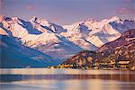 Varenna, Lecco, Lombardy, Italy. A winter sunset over Varenna with snow on the mountains on the backdrop.