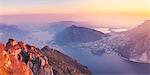 Lecco, lake Como, Lombardy, Italy. Panoramic  view of Lecco and Malgrate from the Resinelli plains at sunset.