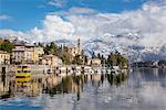 Tremezzo, Como, Lombardy, Italy. Village of Tremezzo in winter time with pristine snow on the mountains in the backdrop.