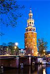 Netherlands, North Holland, Amsterdam. 16th century Montelbaanstoren tower on Oudeschans canal.