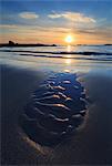 Scotland, Argyll and Bute, Isle of Coll. Patterns on the beach at sunset.