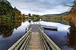 Scotland, Pitlochry. Small jetty and boat on the River Tummel in the autumn.