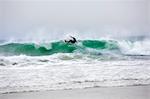 Scotland, Argyll and Bute, Isle of Tiree. A surfer in action.