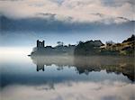 Scotland, Highland, Drumnadrochit. Urquhart Castle and Loch Ness on a misty winter morning.