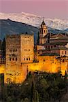 View at dusk of Alhambra palace with the snowy Sierra Nevada in the background, Granada, Andalusia, Spain