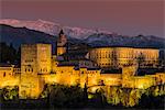 View at dusk of Alhambra palace with the snowy Sierra Nevada in the background, Granada, Andalusia, Spain