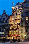 Dusk view of Casa Batllo beautifully adorned with roses to support a local charity organization helping some 1,000 homeless in town, Barcelona, Catalonia, Spain