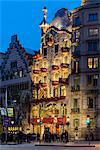 Dusk view of Casa Batllo beautifully adorned with roses to support a local charity organization helping some 1,000 homeless in town, Barcelona, Catalonia, Spain