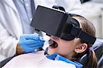 Close-up of girl using virtual reality headset during a dental visit in clinic