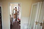 Carpenter working on a wooden door at home