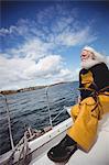 Thoughtful fisherman sitting on fishing boat