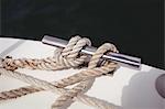 Close-up of rope tied to bollard on boat deck