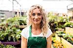 Portrait of female florist standing in garden centre