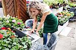 Female florist using laptop in garden centre