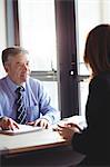 Businessman discussing with colleague in office