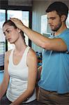 Physiotherapist stretching neck of a female patient in the clinic