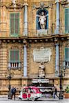 Street scene with scooter taxi in front of the South building at Piazza Vigliena (Quattro Canti) on Corso Vittorio Emanuele in historic center of Palermo in Sicily, Italy