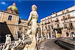 Close-up of various statues at the Pretoria Fountain in Piazza Pretoria (Pretoria Square) with the Dome of Chiesa di San Giuseppe dei Teatini in the background in historic center of Palermo in Sicily, Italy