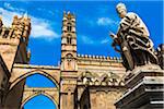 Statue of Archbishop and arcades connecting main building to the palace at the Palermo Cathedral in historic Palermo in Sicily, Italy