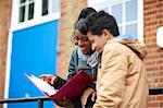 Two young college students revising on campus