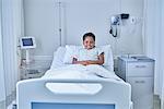 Portrait of girl patient in bed on hospital children's ward