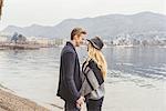 Romantic young couple face to face at misty Lake Como, Italy