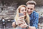Young couple taking smartphone selfie, Lake Como, Italy