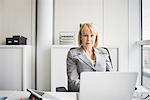 Portrait of mature businesswoman at office desk