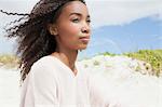 Young woman on beach on windy day