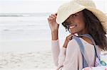 Young woman wearing hat on beach