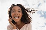 Happy young woman on windy day