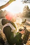 Woman relaxing and having coffee on treetop, Augsburg, Bavaria, Germany