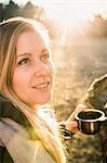 Woman having coffee on sunny day