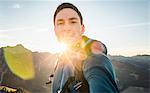 Hiker taking selfie in mountains on sunny day, Kleinwalsertal, Austria