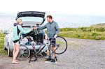 Cyclists preparing bicycle for ride