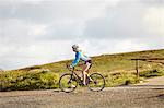 Cyclist riding on gravel road