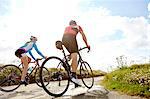 Cyclists riding on country road