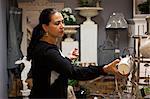 Mature female shopper browsing mugs in gift shop