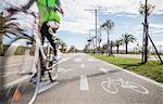 Blurred motion close up of cyclist wear high vis jacket  cycling in cycle lane