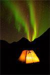 Illuminated tent and Aurora borealis at night, Khibiny mountains, Kola Peninsula, Russia